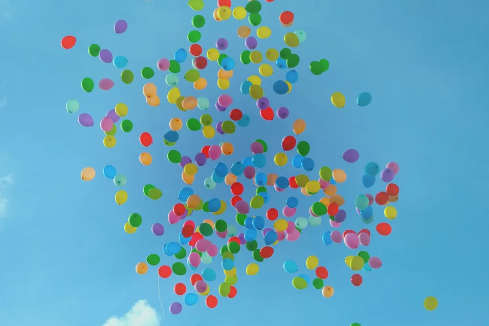 Colorful balloons against a blue sky